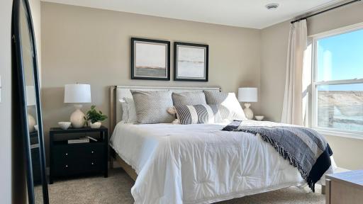 Spacious primary suite with private bath and walk-in closet. Photo of model home. Colors and finishes may vary.