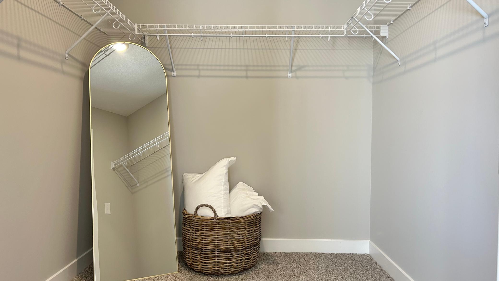 Large primary walk-in closet. Photo of model home. Colors and finishes may vary.