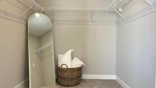 Large primary walk-in closet. Photo of model home. Colors and finishes may vary.