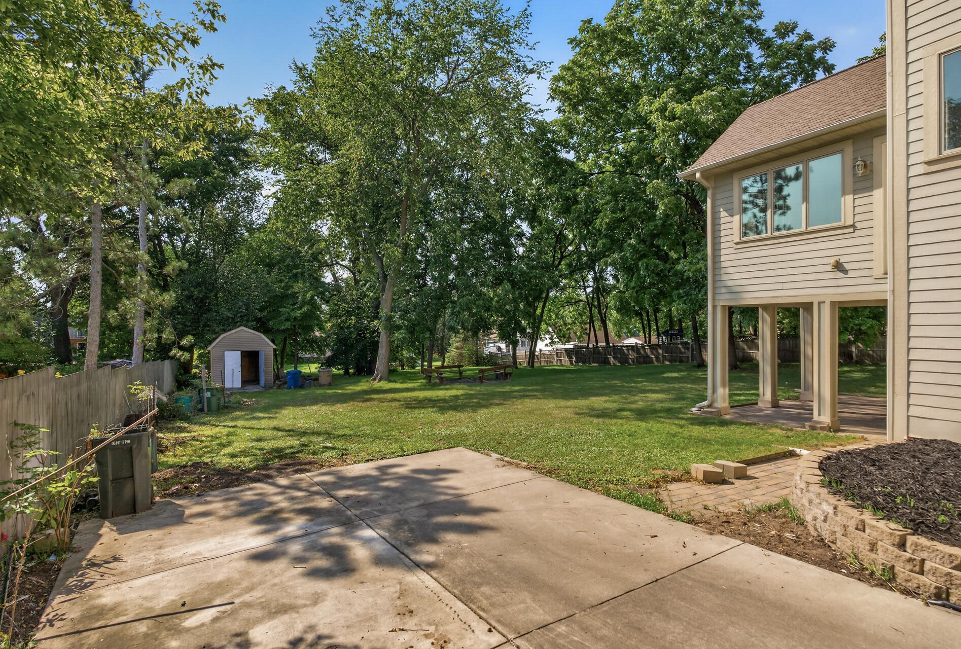 The expansive, flat backyard offers incredible versatility and a beautiful blank canvas for your outdoor vision.