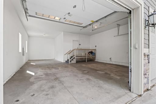 The oversized 3-car garage is impressive in both scale and versatility, with soaring ceilings well beyond standard garage height.