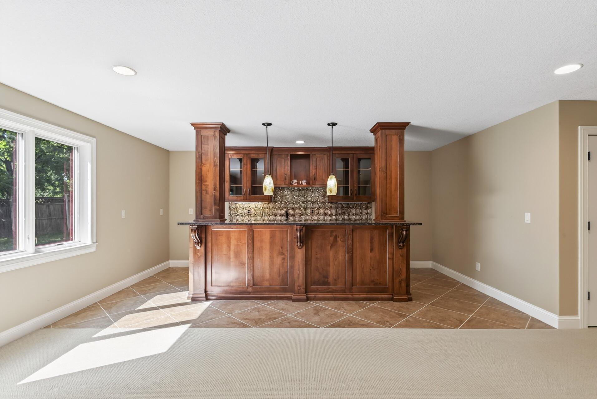 An executive-style bar anchors the walkout lower level, creating a sophisticated destination for entertaining.”