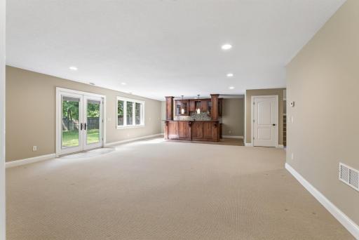 Generous proportions create the perfect setting for movie nights, game days, or evenings spent entertaining around the impressive nearby bar.