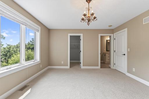 This spacious upper-level bedroom enjoys direct access to one of the homeâs full bathrooms, adding an extra level of privacy and convenience.
