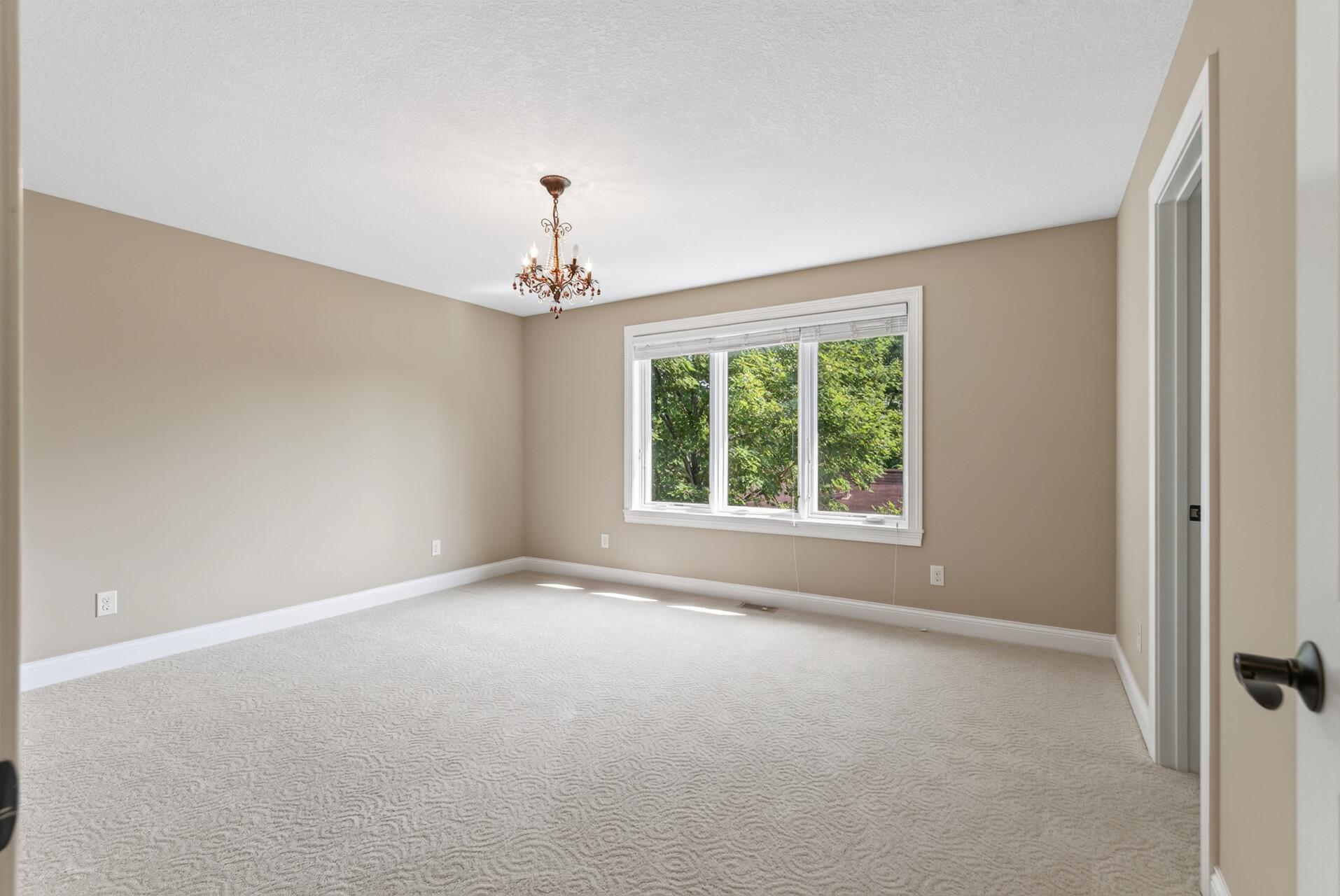 Another spacious upper-level bedroom continues the home’s theme of generous proportions, offering wonderful flexibility for family, guests, or additional workspace.