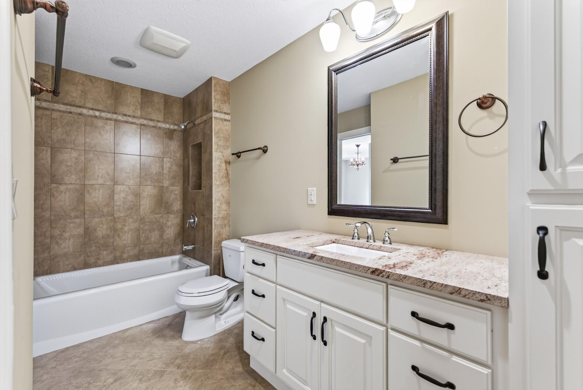 An additional upper-level full bathroom offers beautiful finishes and everyday convenience, thoughtfully positioned to serve the surrounding bedrooms.