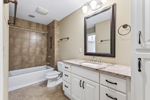 An additional upper-level full bathroom offers beautiful finishes and everyday convenience, thoughtfully positioned to serve the surrounding bedrooms.