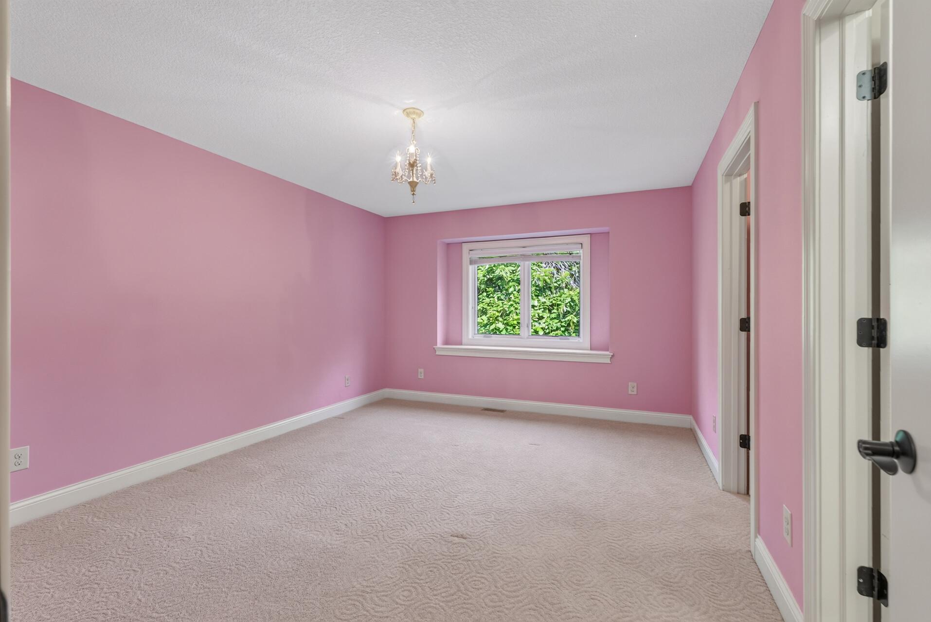 Generously sized and filled with natural light, this upper-level bedroom offers a comfortable and inviting retreat with plenty of room to make it your own.
