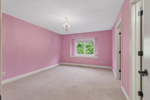 Generously sized and filled with natural light, this upper-level bedroom offers a comfortable and inviting retreat with plenty of room to make it your own.