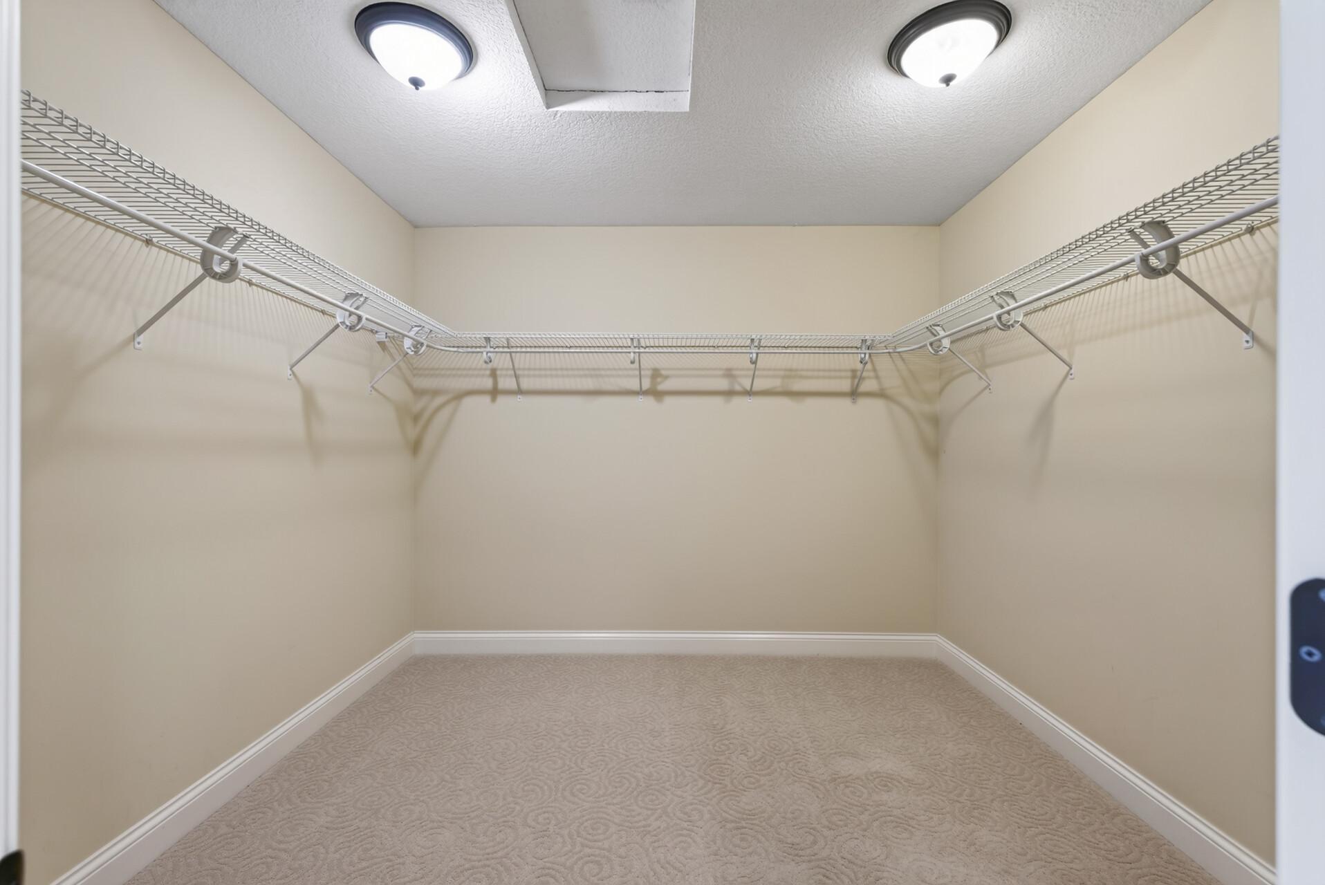 A spacious walk-in closet offers exceptional storage and organization, while a second walk-in closet provides even more room—another thoughtful luxury within the primary suite.