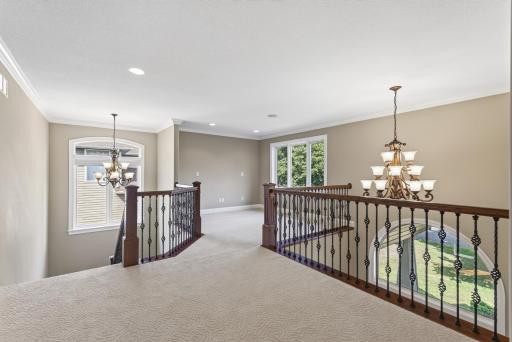 At the center of the upper level, a spacious loft adds another layer of flexibility to the home.