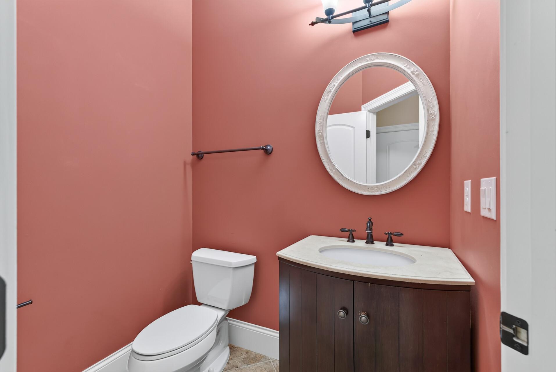 Conveniently located just off the mudroom, the generously sized main-level powder room offers a beautifully finished and welcoming space for guests.