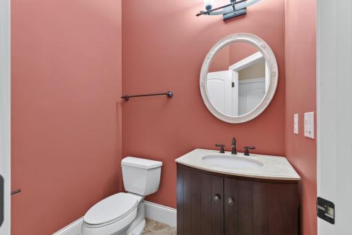 Conveniently located just off the mudroom, the generously sized main-level powder room offers a beautifully finished and welcoming space for guests.