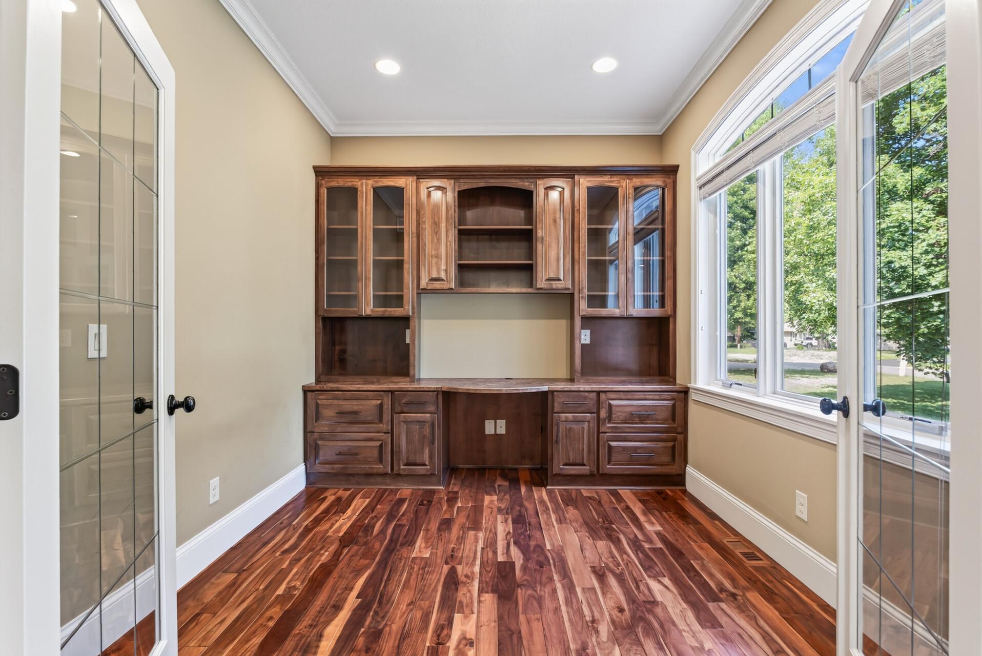 Exceptional built-in cabinetry surrounds the office with both beauty and function, showcasing the level of craftsmanship found throughout the residence.