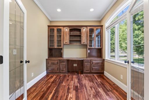 Exceptional built-in cabinetry surrounds the office with both beauty and function, showcasing the level of craftsmanship found throughout the residence.