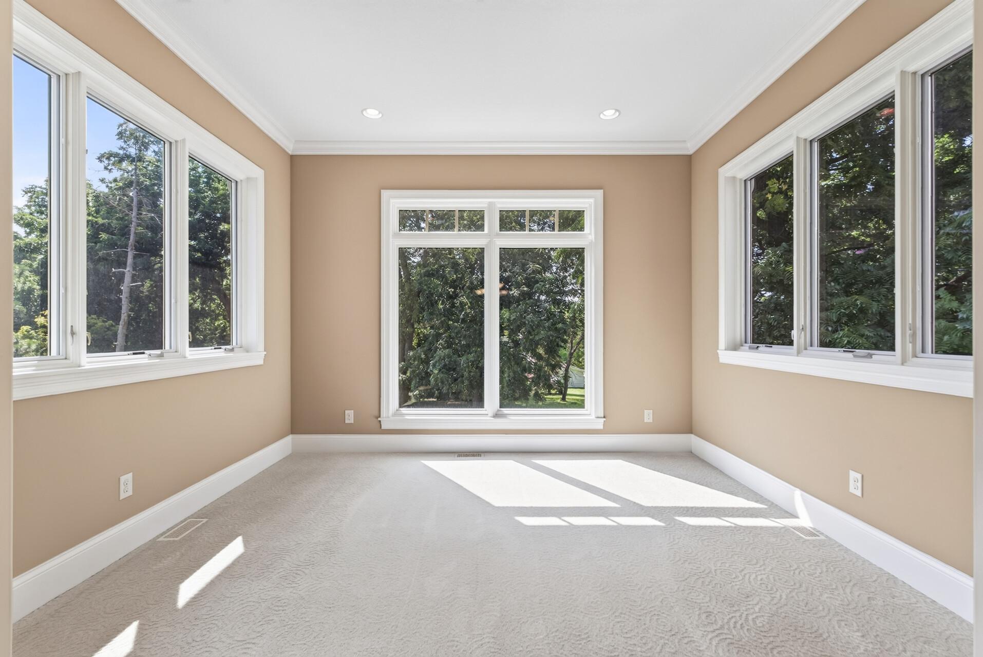 Wrapped in natural light, the sunroom offers a beautiful transition between the home and its outdoor surroundings.