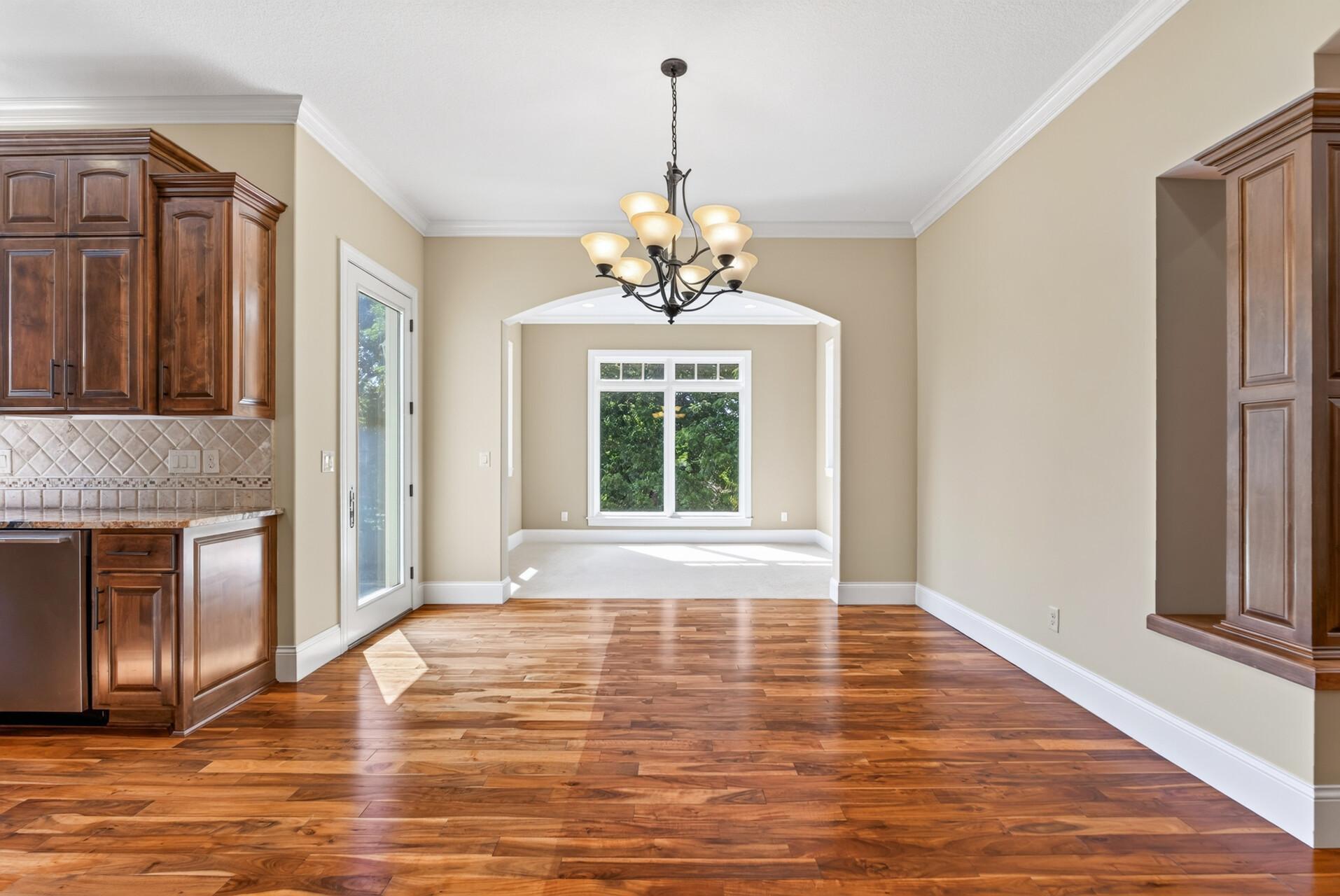The eat-in dining area brings an effortless elegance to everyday meals, offering a welcoming place to gather while remaining beautifully connected to the kitchen and surrounding living spaces.