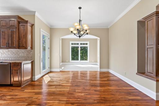 The eat-in dining area brings an effortless elegance to everyday meals, offering a welcoming place to gather while remaining beautifully connected to the kitchen and surrounding living spaces.