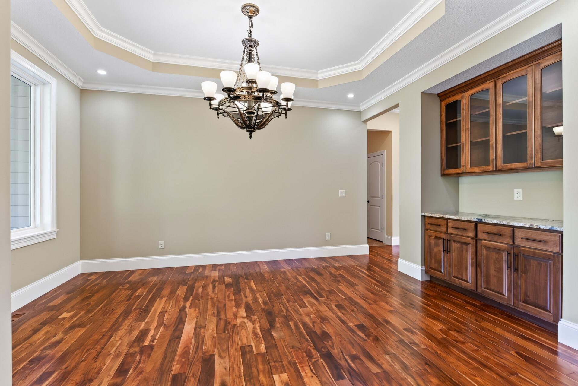 Beautiful cove lighting highlights the detailed ceiling, creating a warm, sophisticated ambiance and adding another layer of architectural elegance to the space.