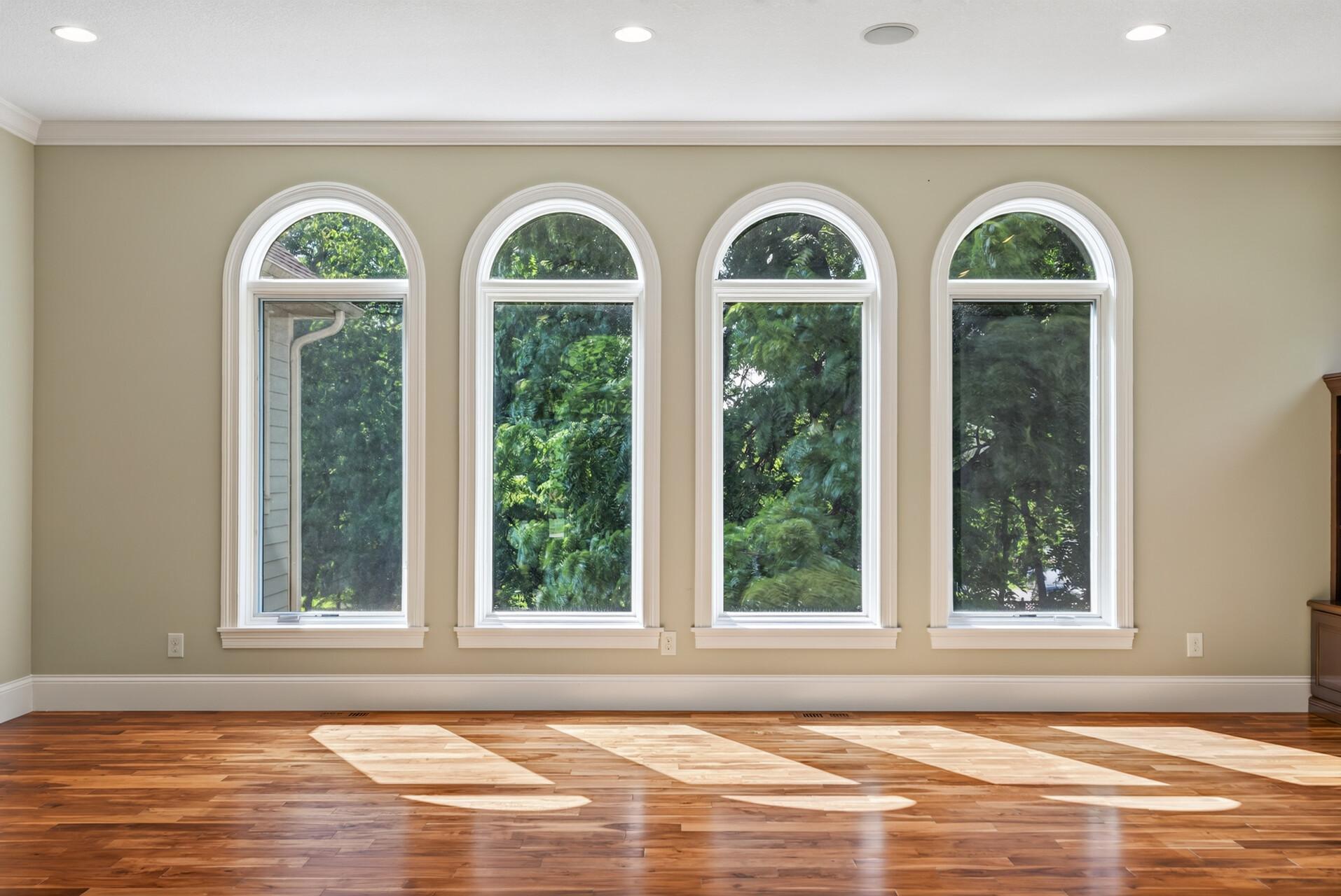 Natural light pours through oversized windows, adding to the home’s open and airy feel.