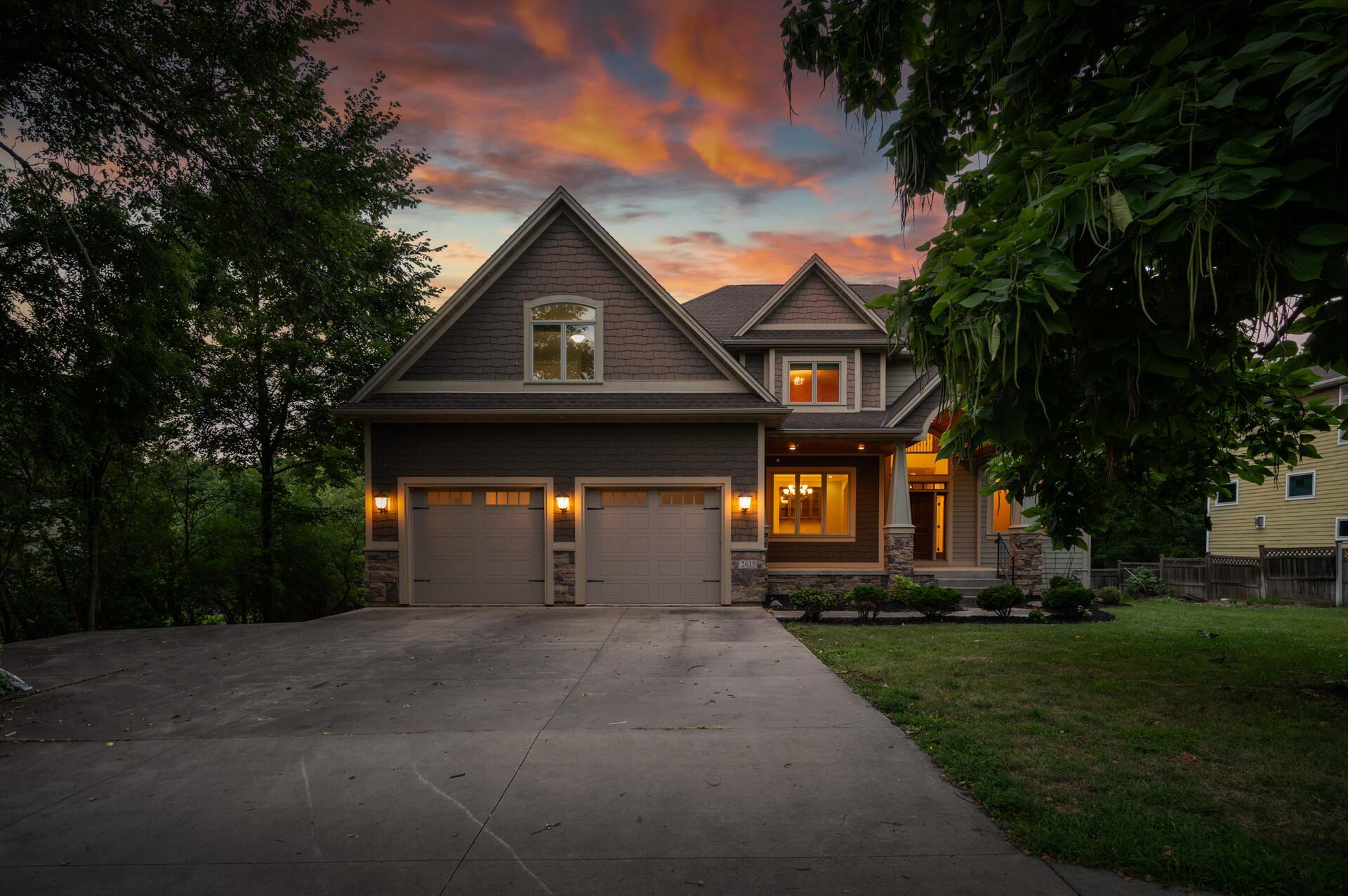 An expansive concrete driveway offers exceptional parking and flexibility, including a dedicated side drive perfectly suited for a boat, camper, trailer, or additional recreational vehicles.