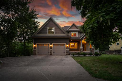 An expansive concrete driveway offers exceptional parking and flexibility, including a dedicated side drive perfectly suited for a boat, camper, trailer, or additional recreational vehicles.