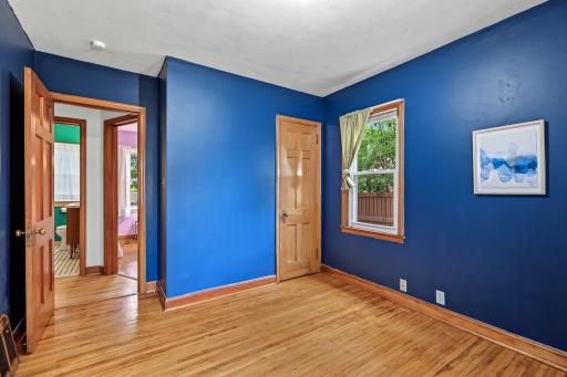 This main level bedroom is the larger of the two main level bedrooms