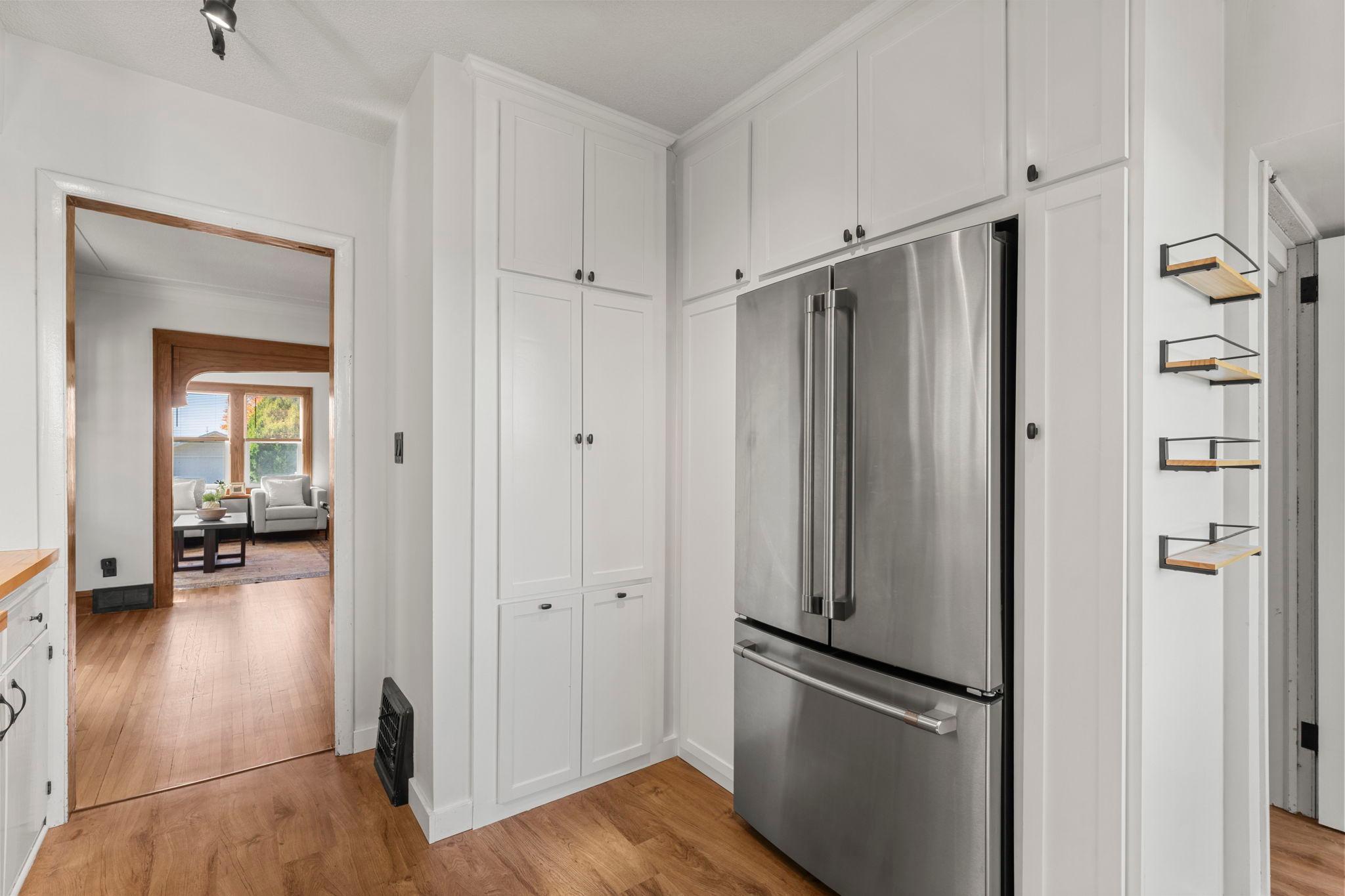 Custom cabinets surround the refrigerator