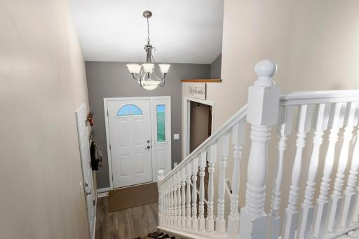 The foyer leads to the main entrance, garage and either level.
