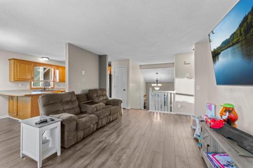 The living room has LVP flooring and has an open floor concept.