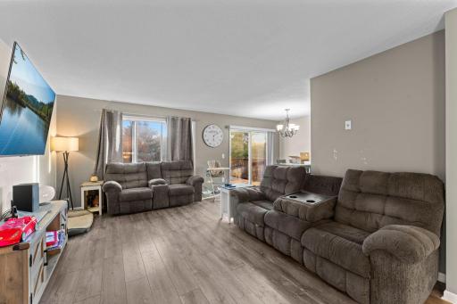 The living room is open to the dining area and leads to the rear deck.