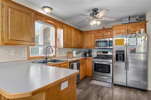 The kitchen is well appointed with raised panel oak cabinetry, stainless steel appliances, a pantry and a snack bar!