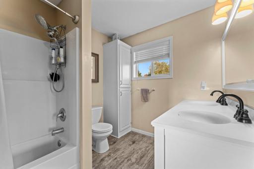 The main floor bathroom has dual sinks and plenty of storage cabinetry.