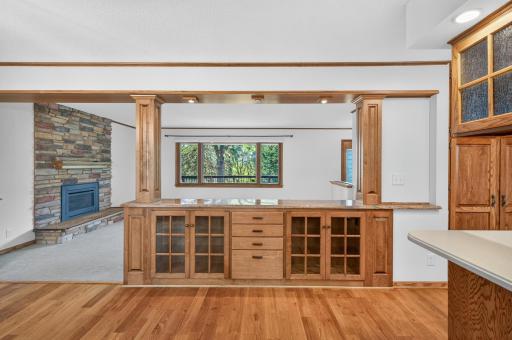 A custom dinette: overhead lighting, glass door cabinets, and granite counters.