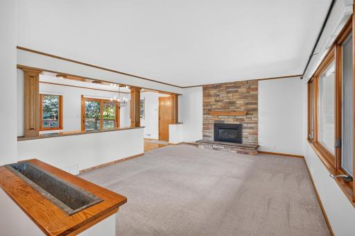 The large living room is highlighted by oversized front window and lovely stone wall fireplace.