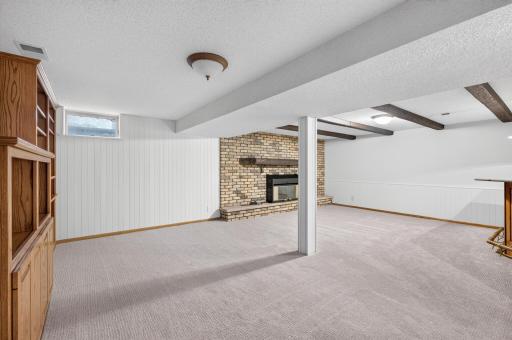 An entertainer's dream! Brick fireplace with insert, lots of cabinetry, and a private dry-bar.