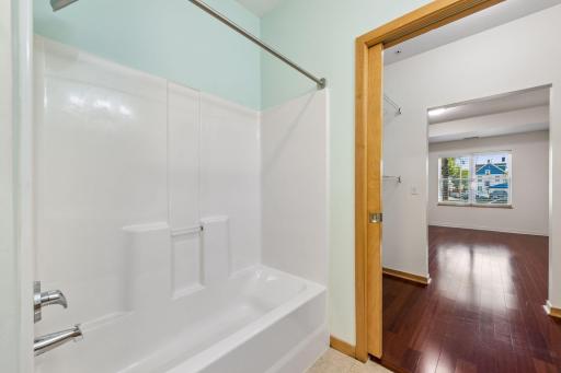 Tub and shower combination with easy access directly from the walk-in closet and primary bedroom.