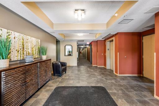Welcoming main-level lobby featuring comfortable seating, elevator access, and convenient interior hallways leading to residential units.