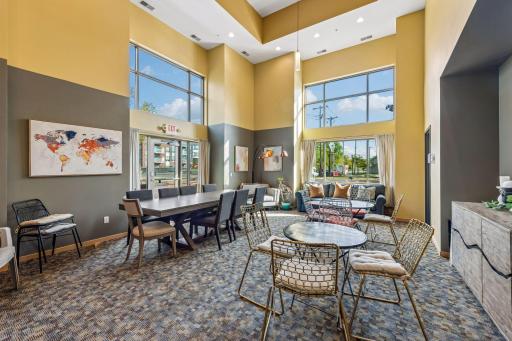 Community party room offers a spacious gathering area with large windows, high ceilings, and plenty of natural light.