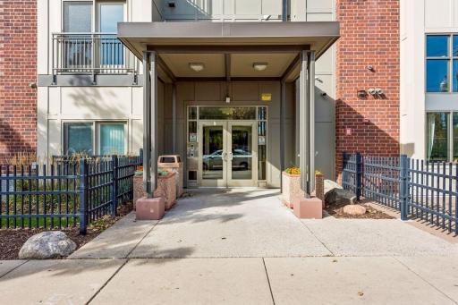 Main entrance to Midtown Exchange Condos on the Greenway featuring secure building access and a covered entry for added convenience.