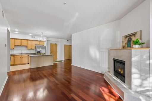 Bright and spacious living room with an open layout, gas fireplace, and plenty of natural light, creating a comfortable and inviting main living space.