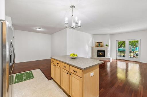Kitchen opens into the bright living room with natural light and a designated dining area, creating an open and functional main living space.
