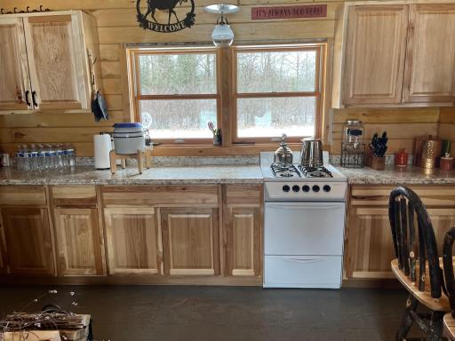 Cabin Interior 5 stove and new hickory cabinets_sink not shown.jpeg