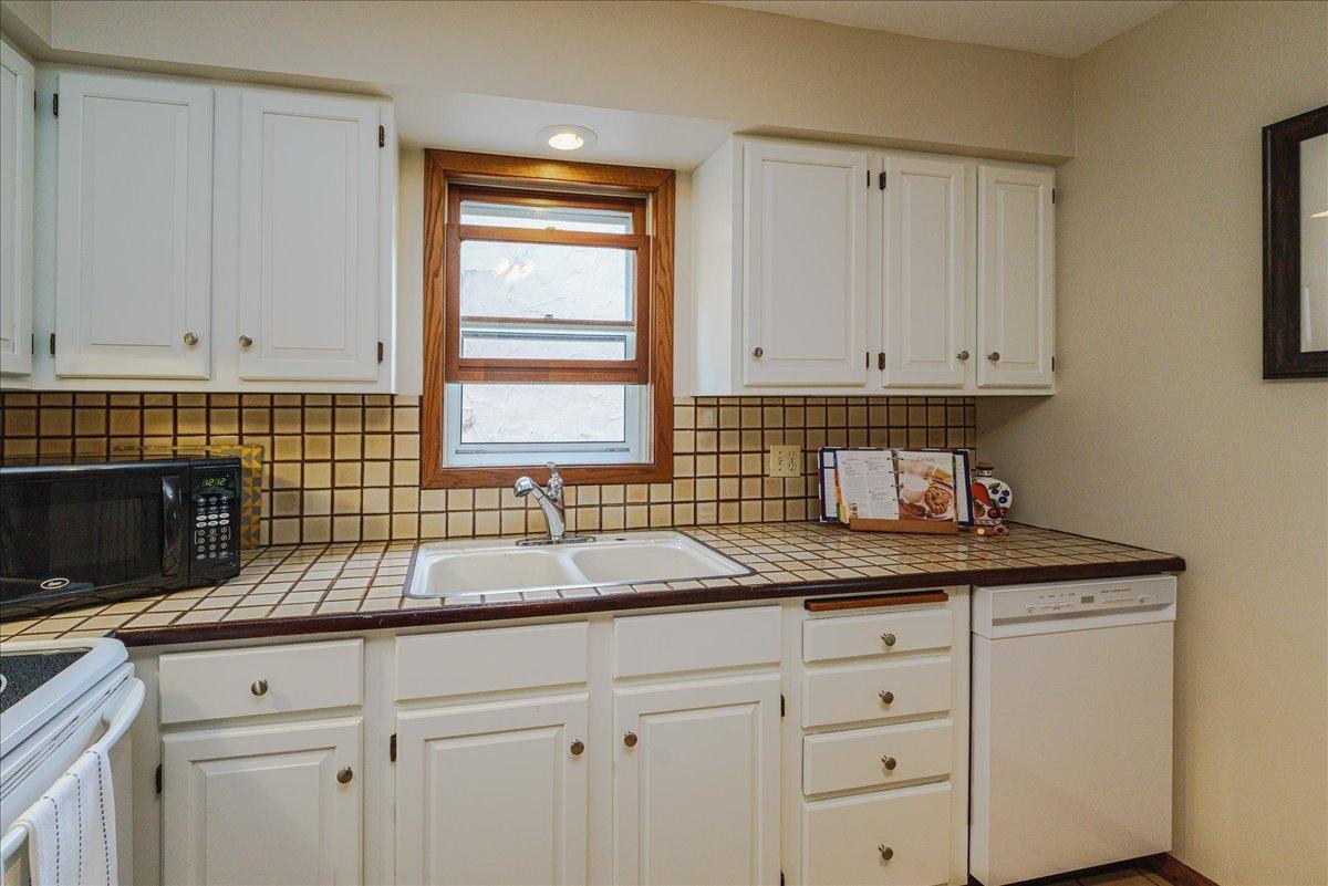A window above the sink brings natural light to the kitchen.
