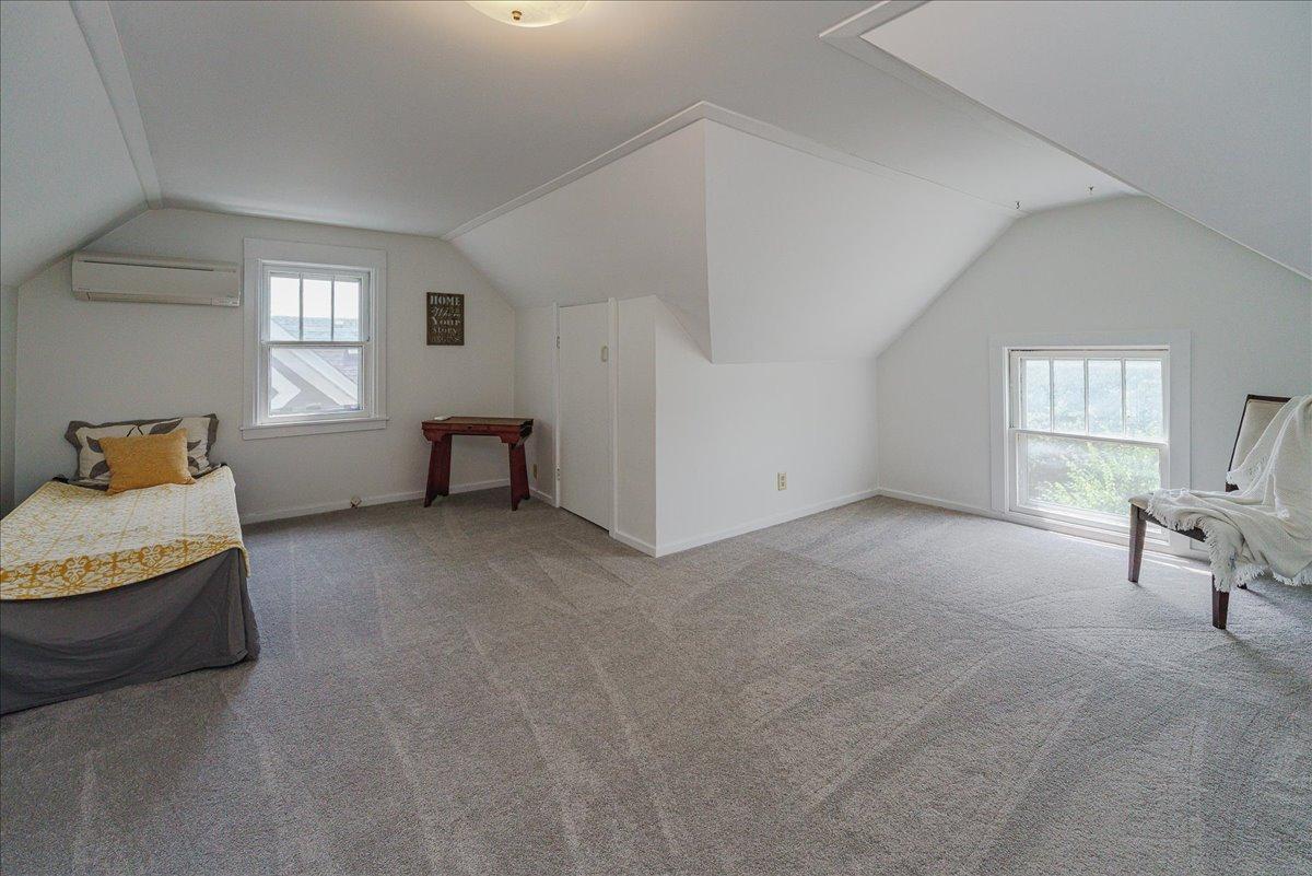 An L-shaped bedroom complete with double closets.