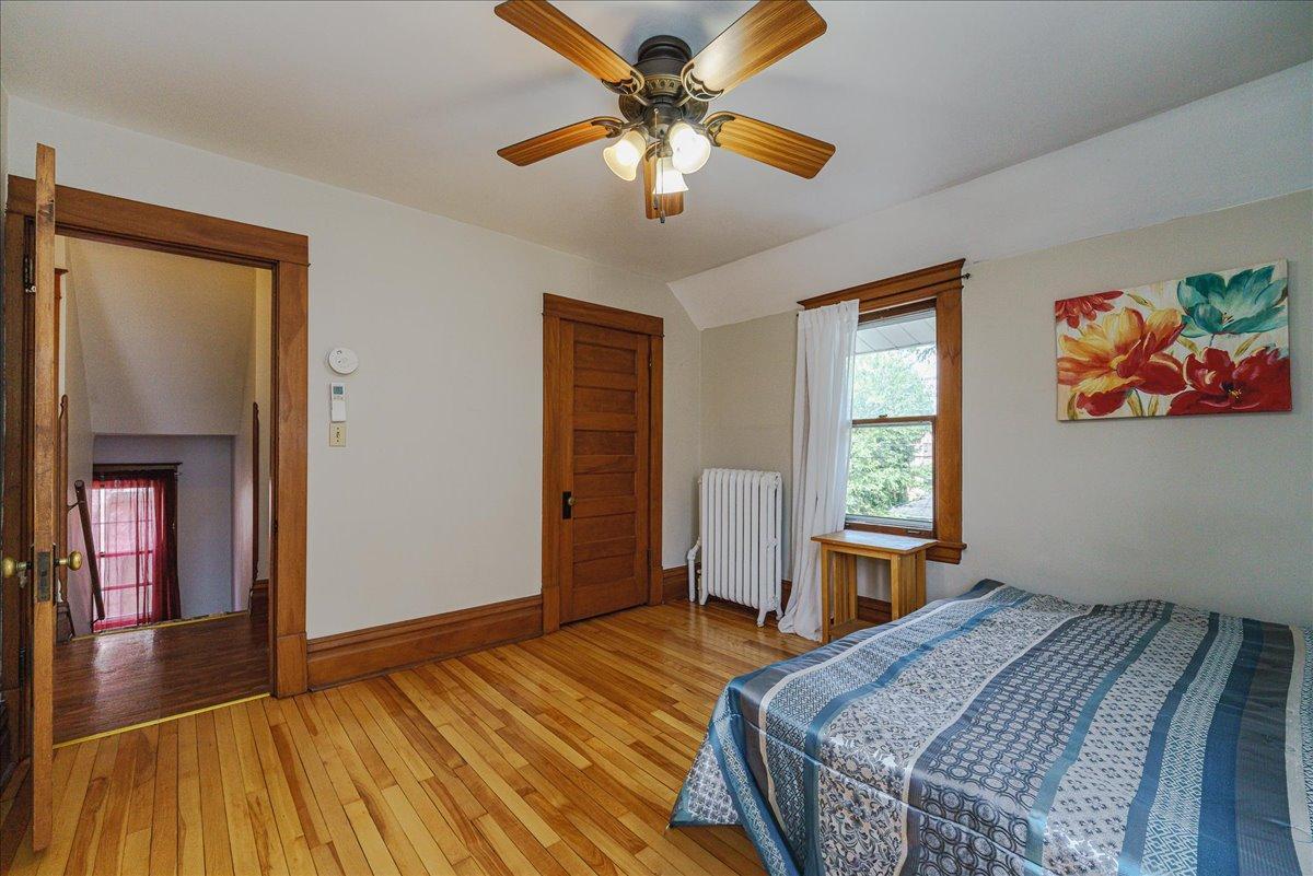 Hardwood flooring and substantial wood trim give this bedroom a warm, classic feel.
