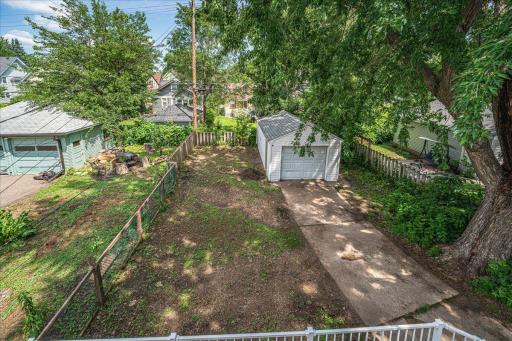 Mature trees shade the backyard, with a detached garage.