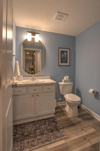Main floor powder room located right off garage
