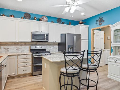 Open kitchen with granite counters, copper sink, updated cabinets