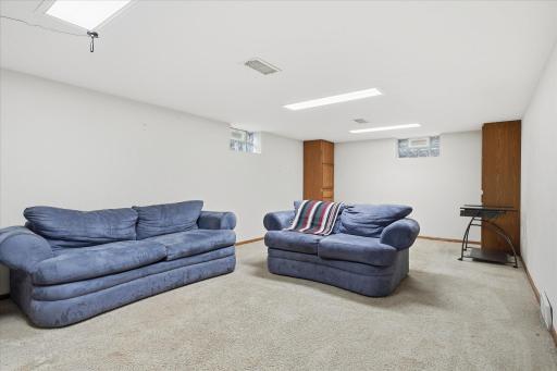 Spacious lower-level family room featuring neutral finishes, comfortable carpeting, and plenty of room for entertaining, relaxing, or creating a recreation space.